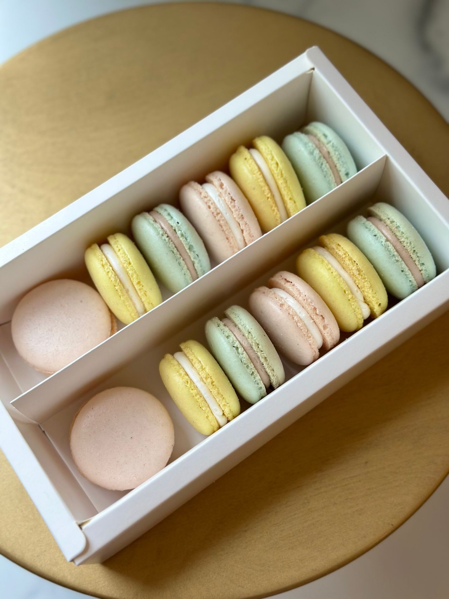 Pastel French macarons in a white gift box
