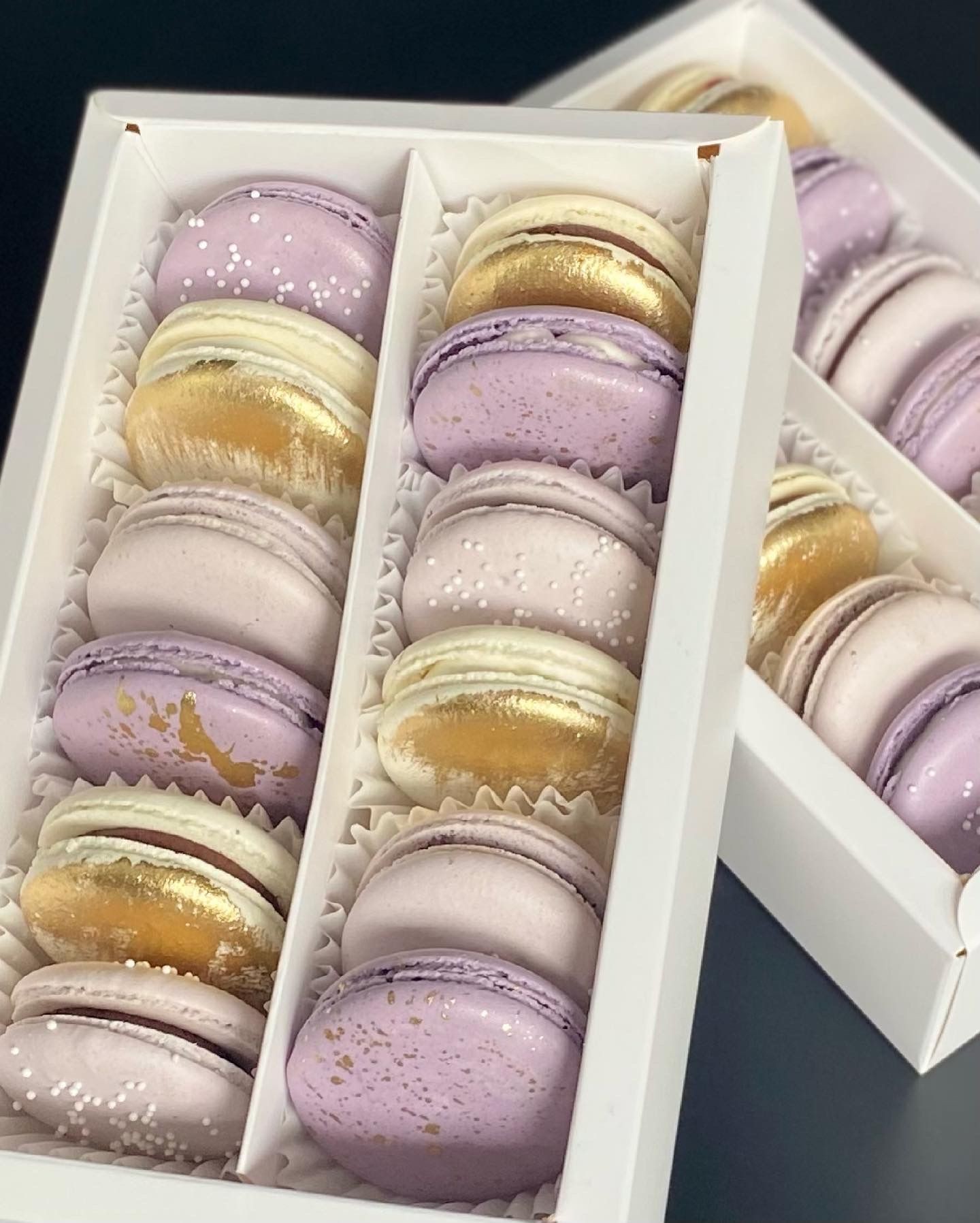 Purple ombre and gold macarons in a white gift box